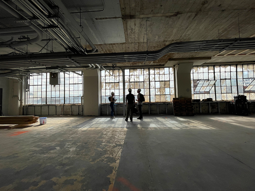 large factory windows and open space in new headquarters